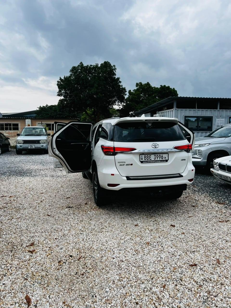 Rear view of a white Toyota Fortuner with the tailgate area visible