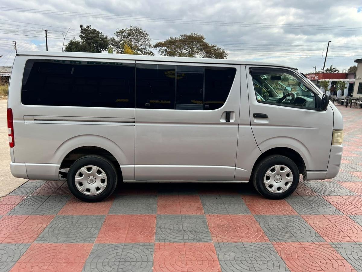 Side profile of the silver Toyota Hiace minibus in standard trim